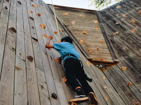 a person climbing a wooden wall
