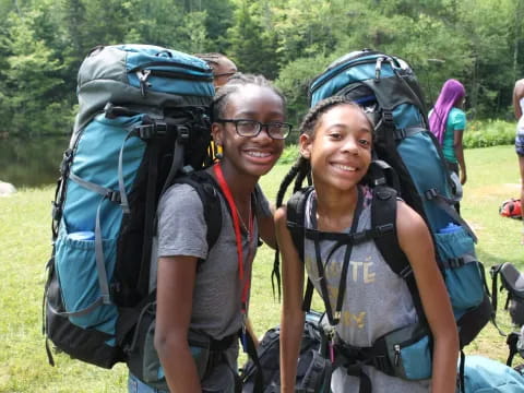 a man and woman with backpacks