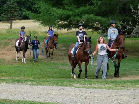 a group of people riding horses