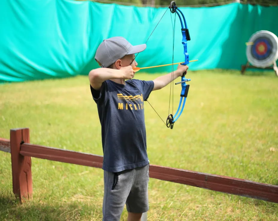 a boy holding a bow and arrow