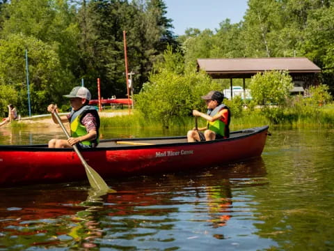 a couple of men in a canoe