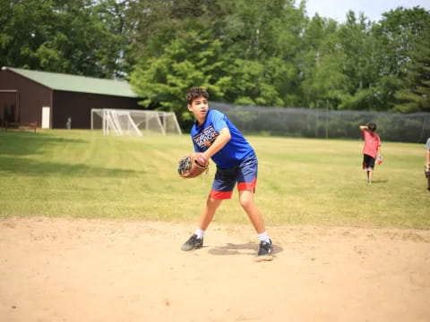 a person in a blue shirt throws a baseball