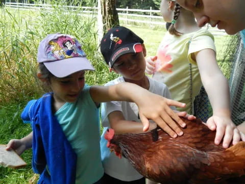 a group of children holding a large turkey