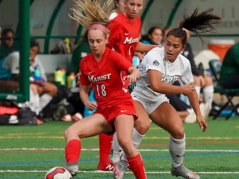 girls playing football on a field
