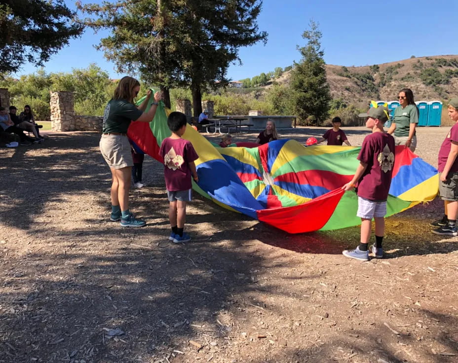 a group of people holding a kite