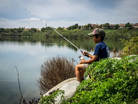 a man fishing on a rock