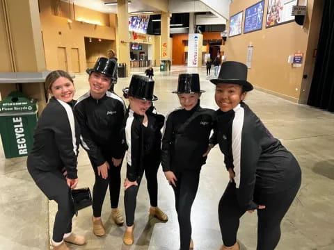 a group of people wearing black and white hats