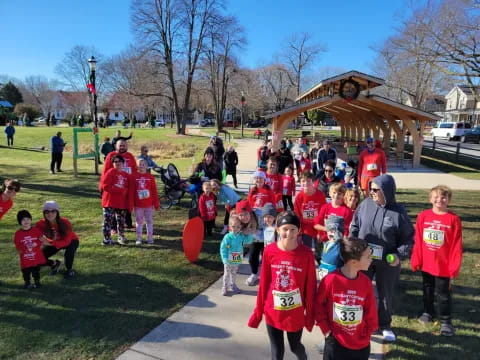 a group of children in red shirts