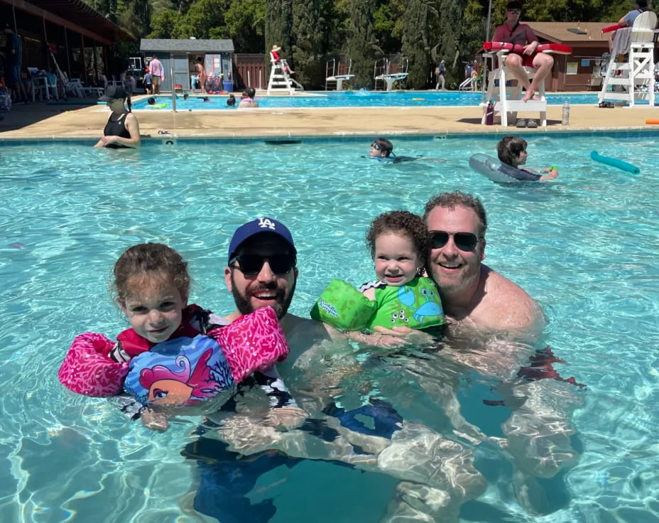 a person and two children in a pool