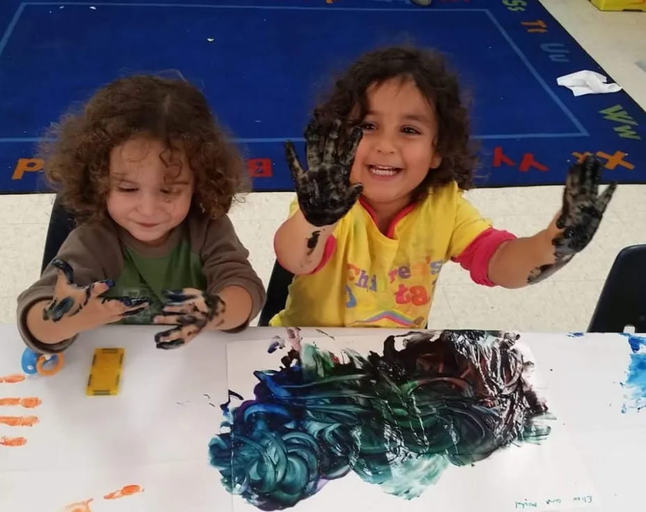 a couple of young girls painting