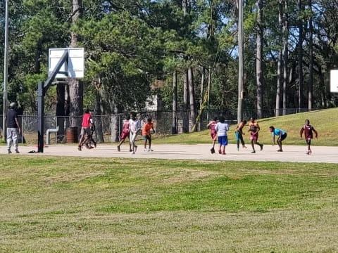 a group of people playing basketball