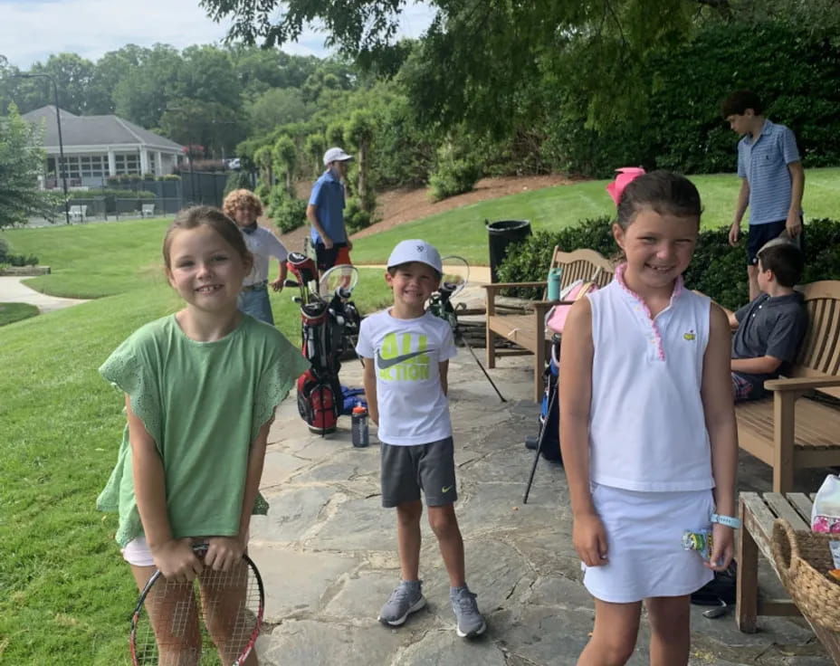 a group of kids standing outside