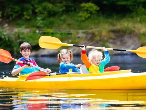 a group of kids in a canoe