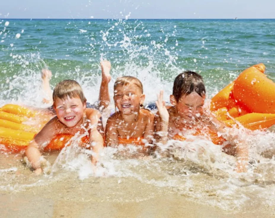 a group of kids in the water