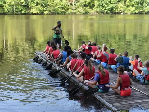 a group of people rowing a boat