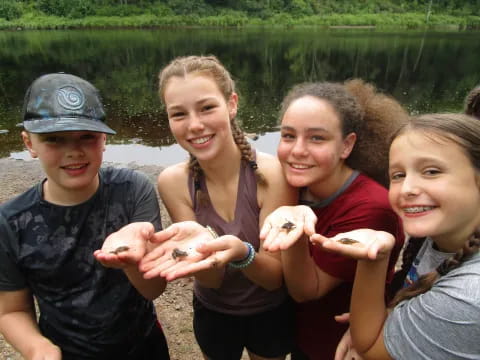 a group of people holding fish