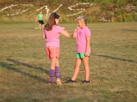 two girls in a field
