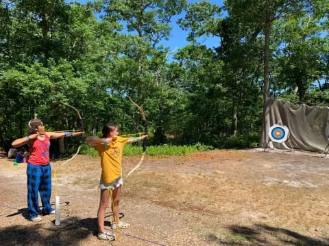 a couple of boys shooting bows