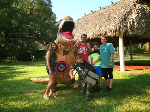 a group of people posing with a person in a garment