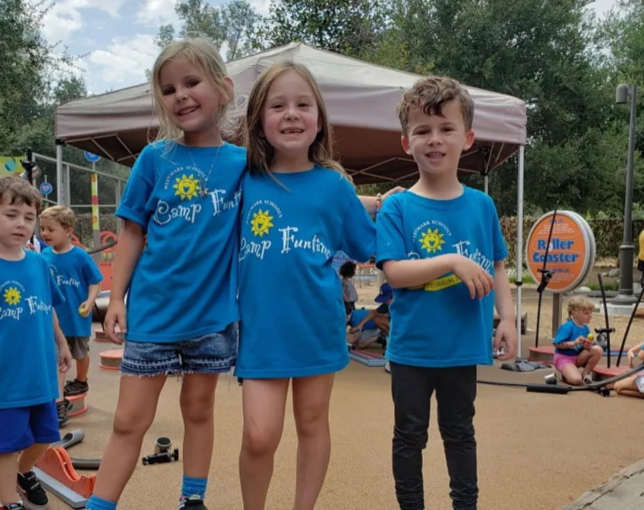 a group of children in blue shirts
