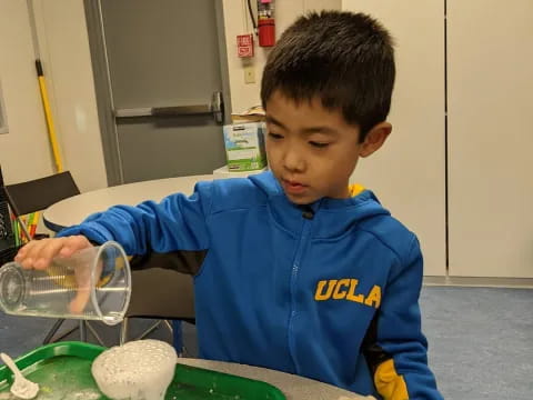 a boy sitting at a table