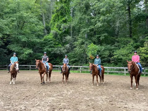 a group of people riding horses