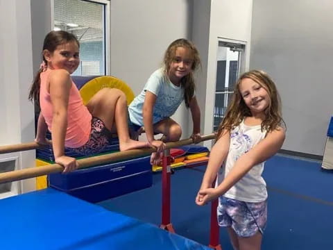 a group of girls playing on a trampoline