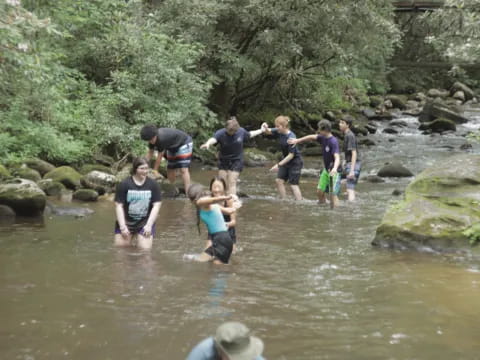 a group of people standing in a river