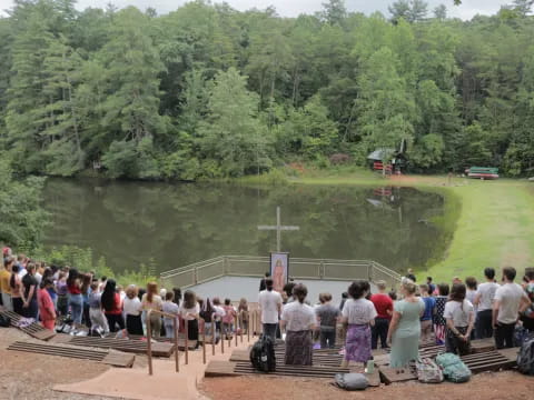 a group of people standing on a dock over a body of water