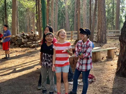 a group of people posing for a photo in the woods