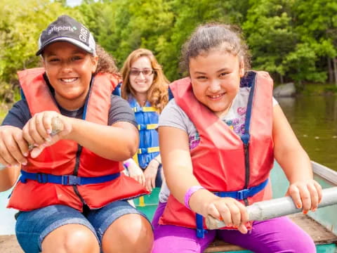 a group of kids in a boat