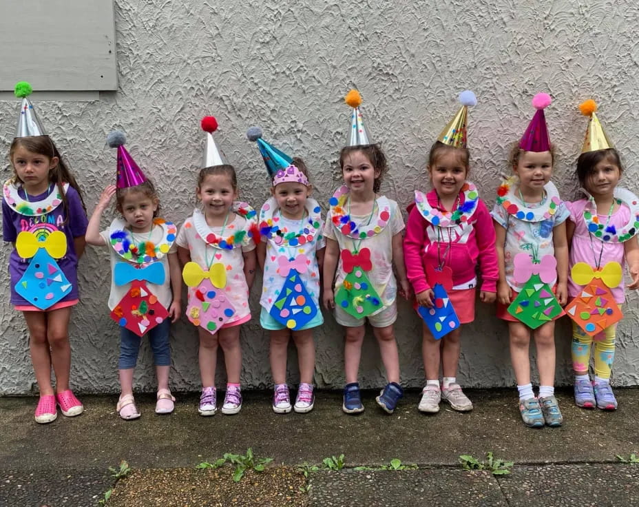 a group of girls wearing party hats