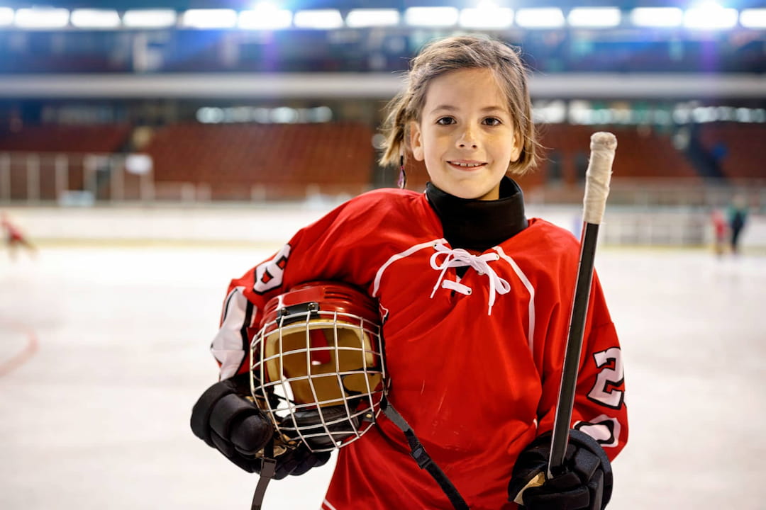 a girl holding a hockey stick
