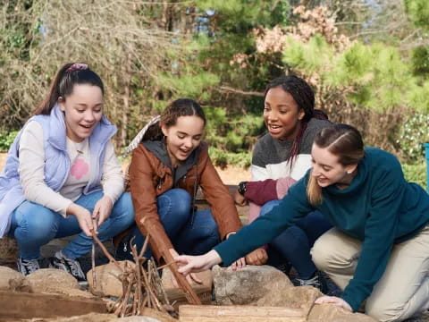 a group of women sitting on rocks