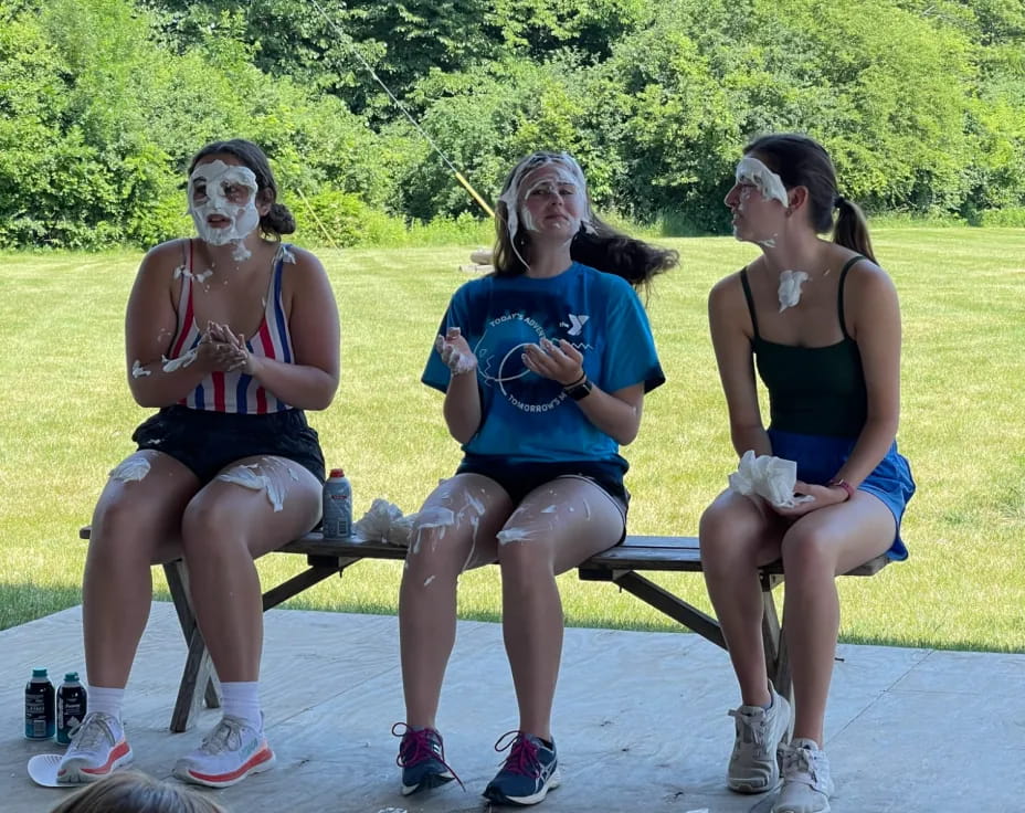 a group of women sitting on a bench