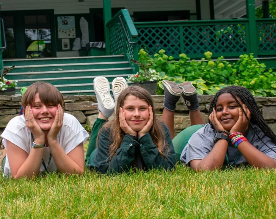 a group of girls lying in the grass