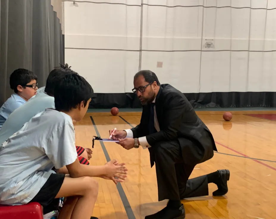 a person in a suit playing a game with other men