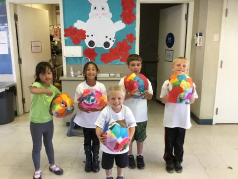 a group of children holding toys