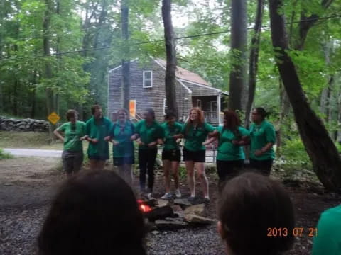 a group of people standing in a line in front of a house