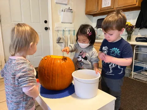 kids around a pumpkin