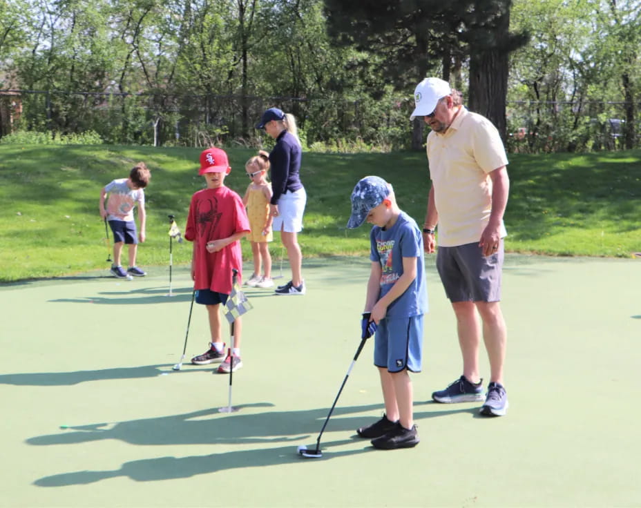 a group of people playing golf