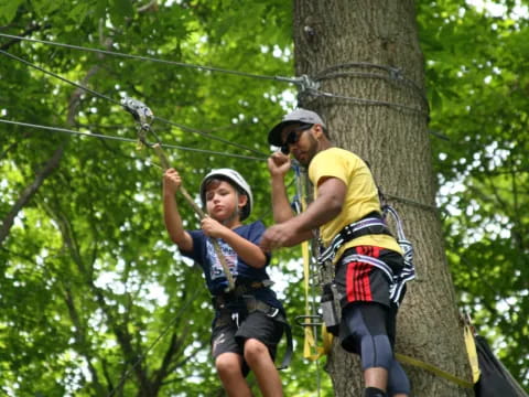 a man and a child climbing a tree