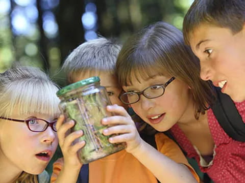 a group of people holding a jar