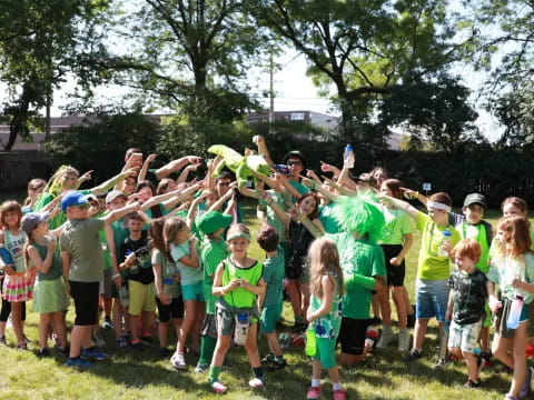 a group of children in matching green shirts and matching outfits