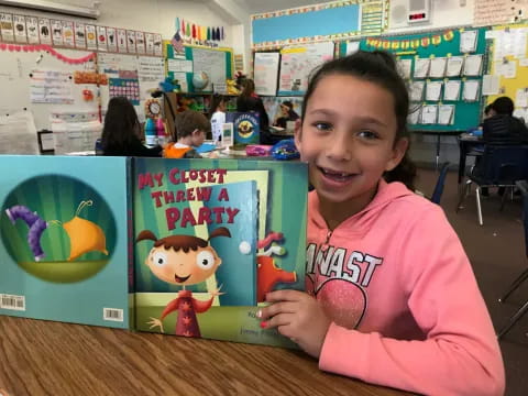 a girl holding a book