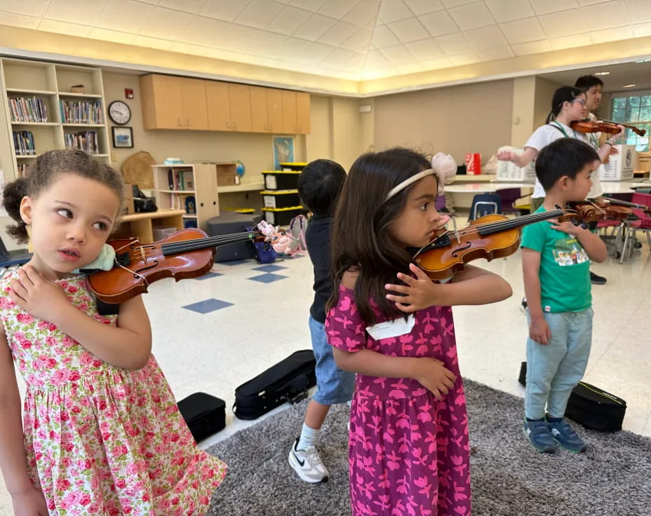 a group of children playing violin