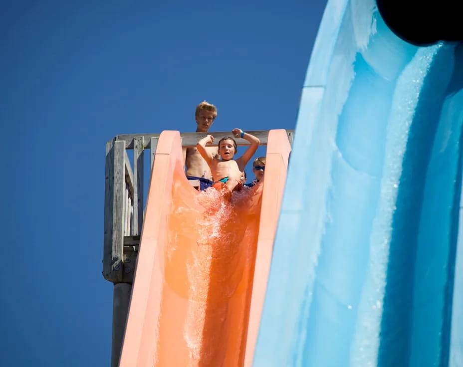 two kids on a water slide