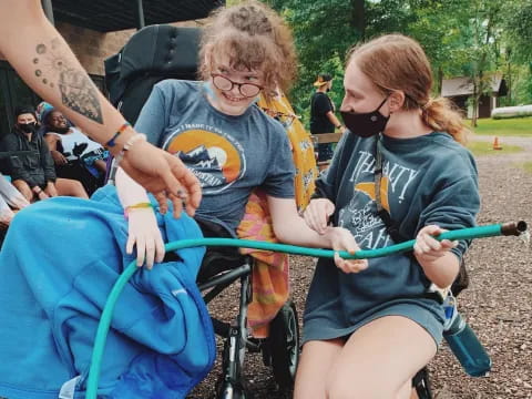 a person helping a girl ride a bike