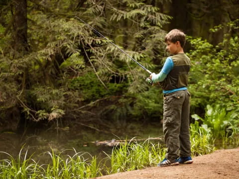 a boy fishing in a river