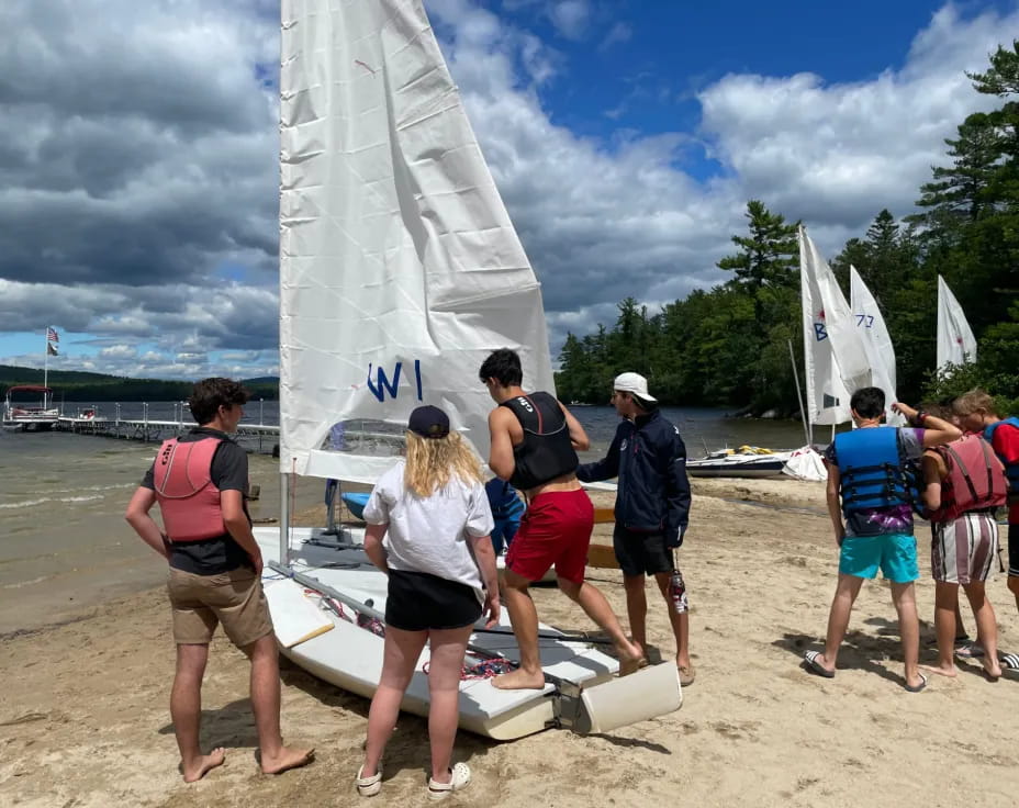 people with surfboards on beach